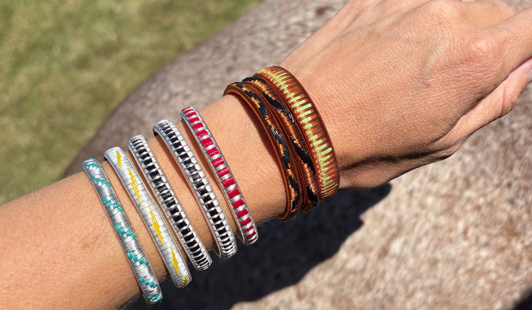 The three widths worn together along a forearm